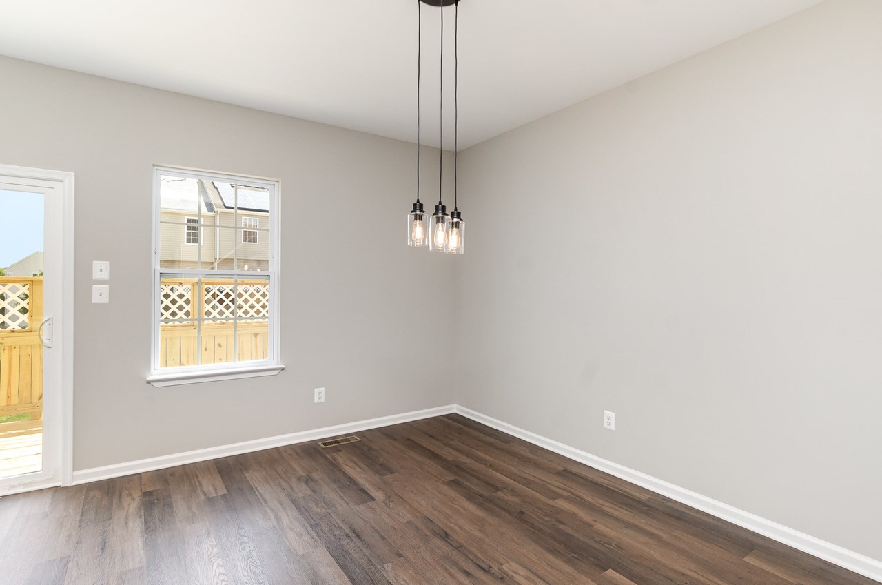 dining room with new luxury vinyl floors & chandelier